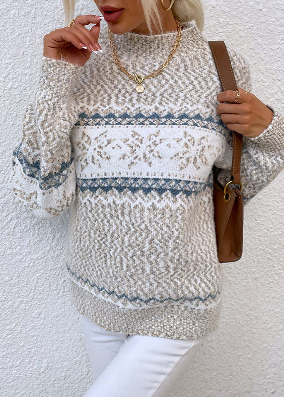 Person wearing a patterned sweater against a white background