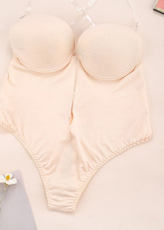 Beige bikini set on a light surface with a blurred background