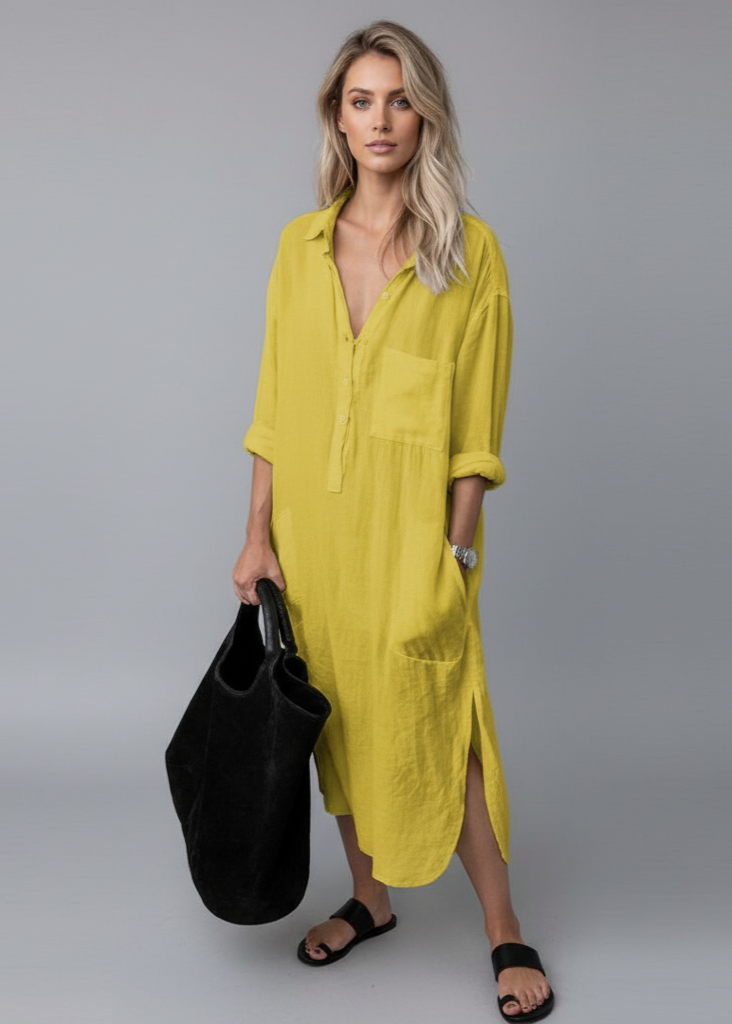 Woman wearing a yellow dress holding a black bag on a gray background