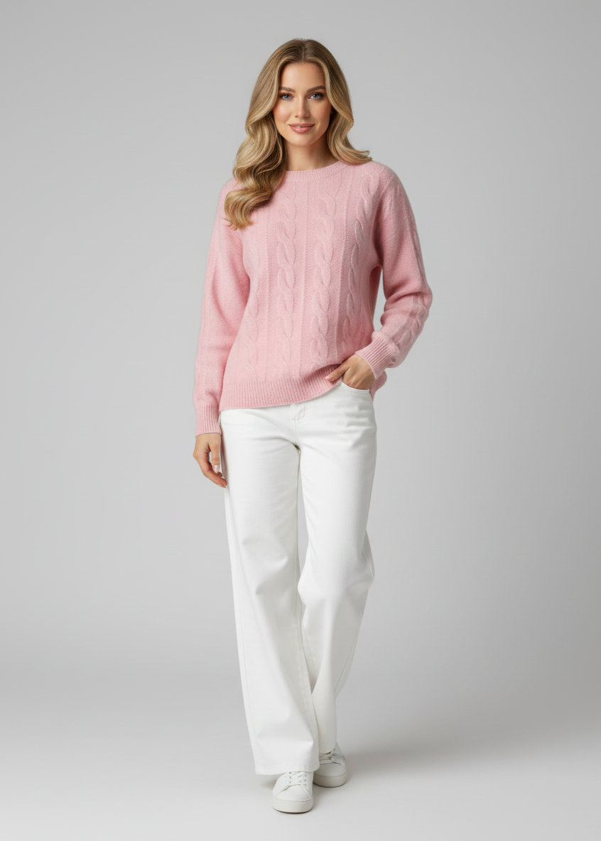 Woman wearing a pink sweater and white pants on a gray background