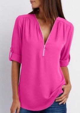 Woman wearing a bright pink blouse with a white background