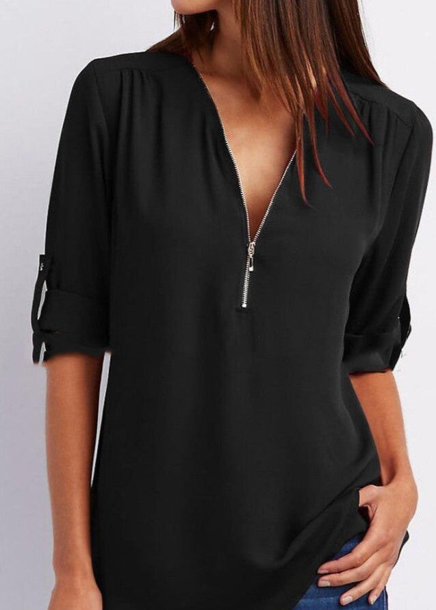 Black blouse with a deep neckline and short sleeves on a plain background