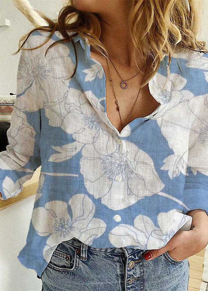 Person wearing a blue floral shirt with a blurred background