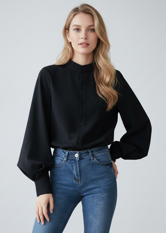 Woman wearing a black blouse and blue jeans on a light gray background